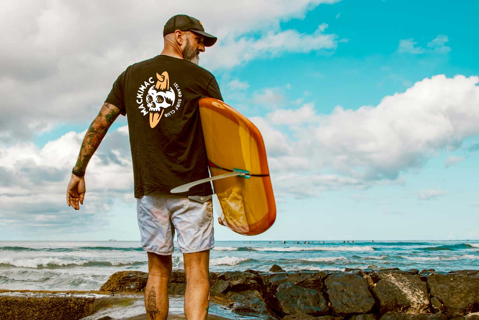 Photo of man holding surfboard